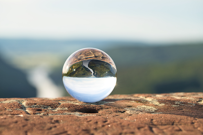 A glass ball sat on a mountainside (motivate and engage employees blog)