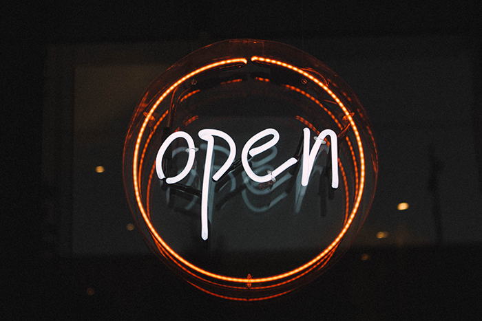 A neon sign saying "open" - open innovation funnel